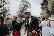 Groom with puppy on wedding day