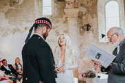 Bride laughing with groom at wedding ceremony