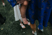 Wedding guest holding child with bare feet