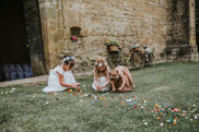 Flower girls picking up confetti