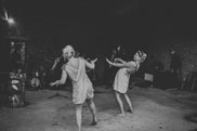 Bridesmaids dancing in front of live band