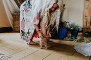 Bride fastening her shoes