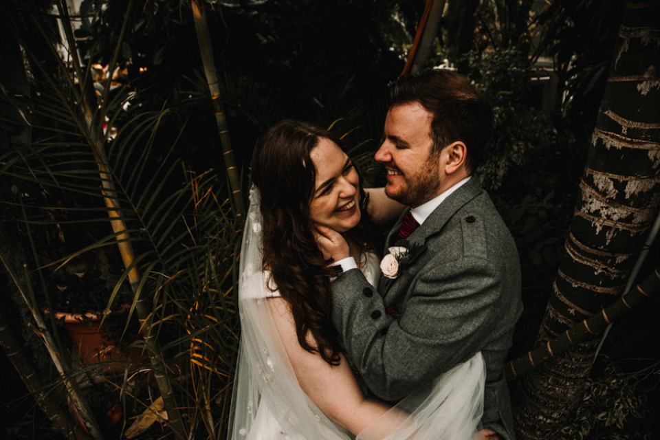 couple laughing in the palms at sefton park wedding venue