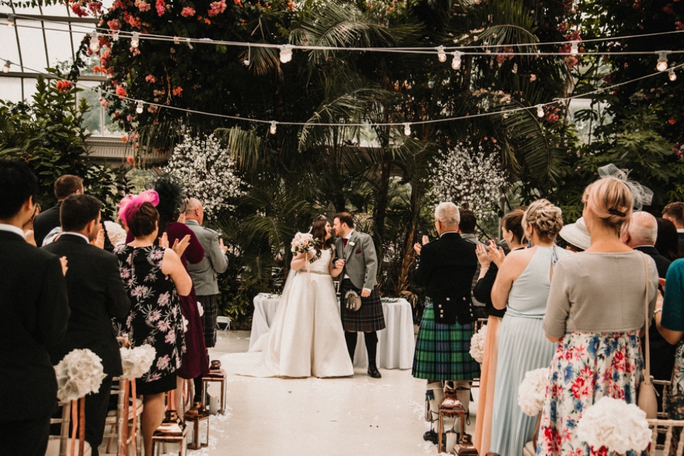 bride and groom walking down sefton wedding venue aisle