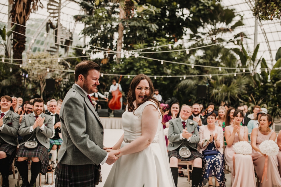 bride and groom during ceremony , sefton palm house