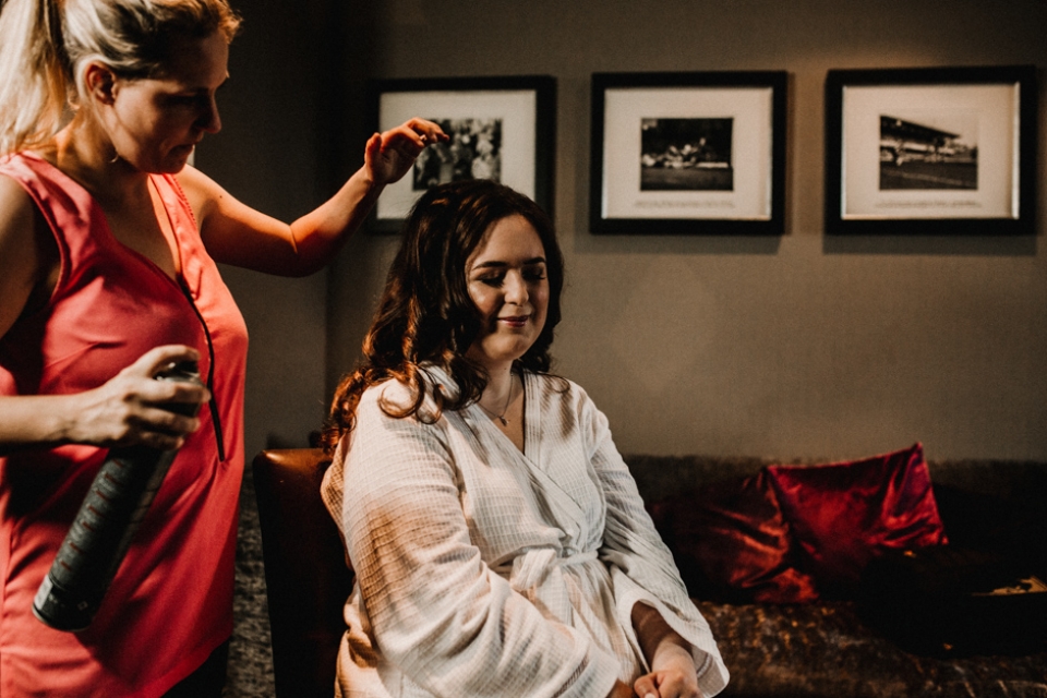 bride having her hair finished on her wedding morning