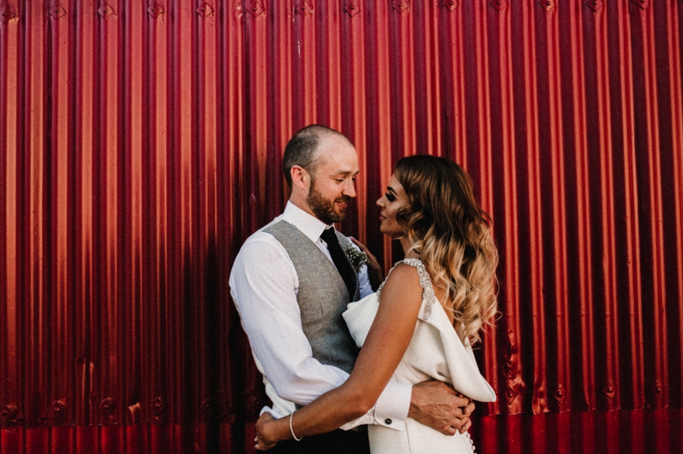 bride and groom enjoying two minutes kissing and cuddling on their wedding day