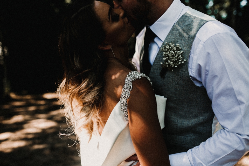 bride and groom kissing in the lake side