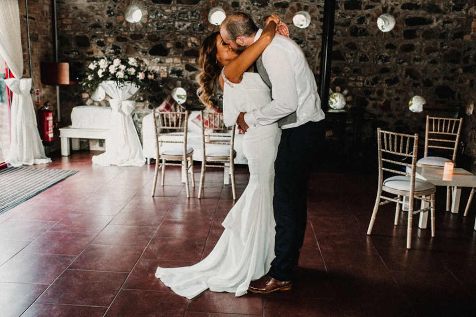 first dance bride and groom kissing on dance floor