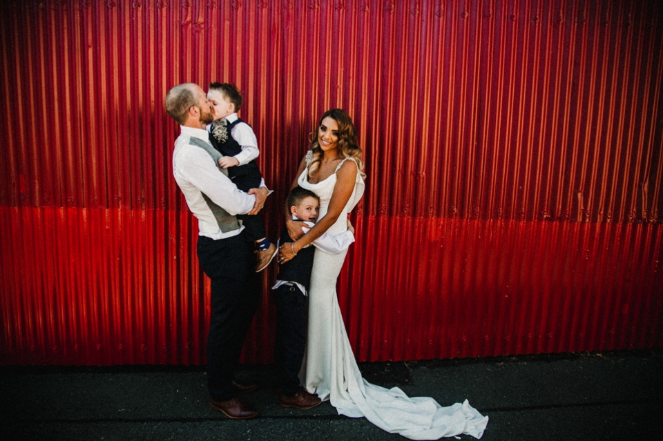 bride and groom and their two sons  on their wedding day