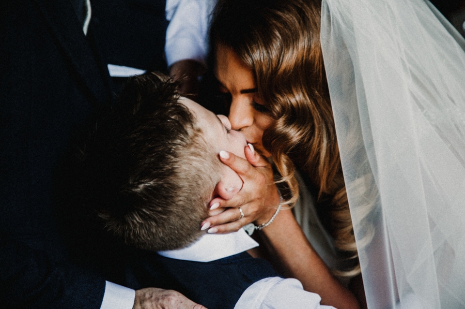 bride kissing her son after the ceremony