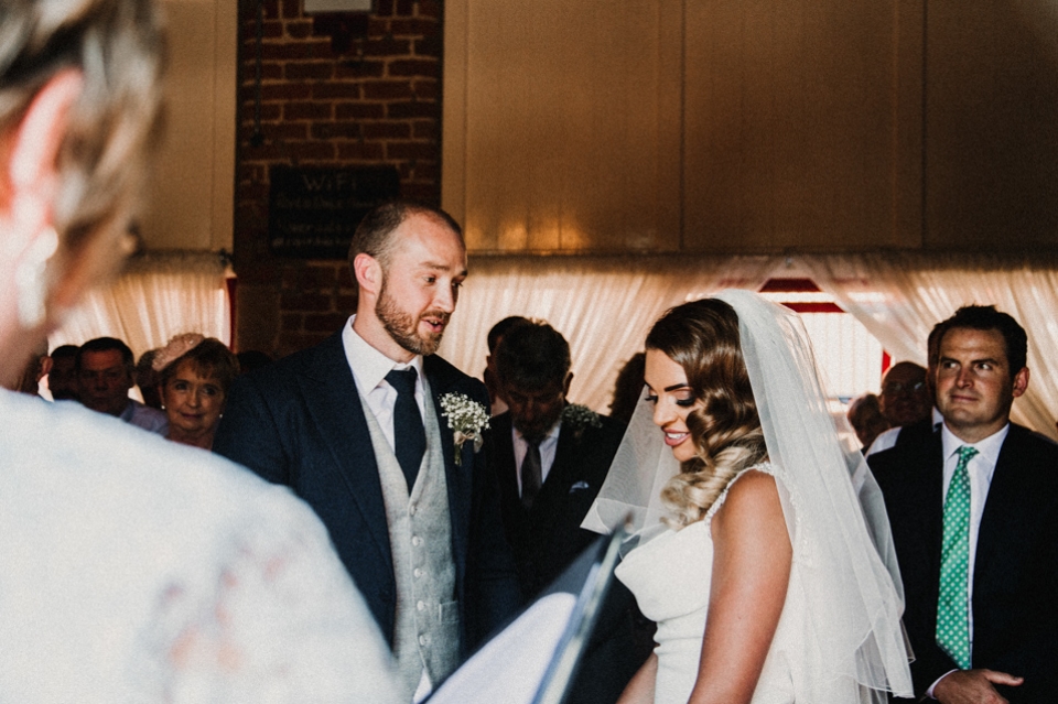 bride looking bashful during the vows