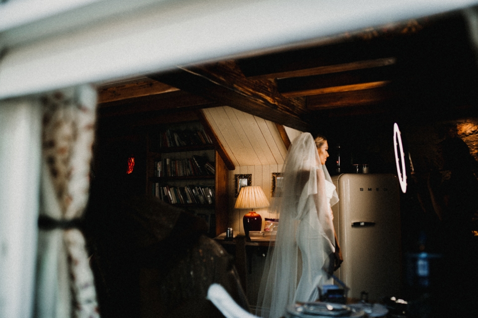 bride having her makeup touched up before leaving for the wedding ceremony