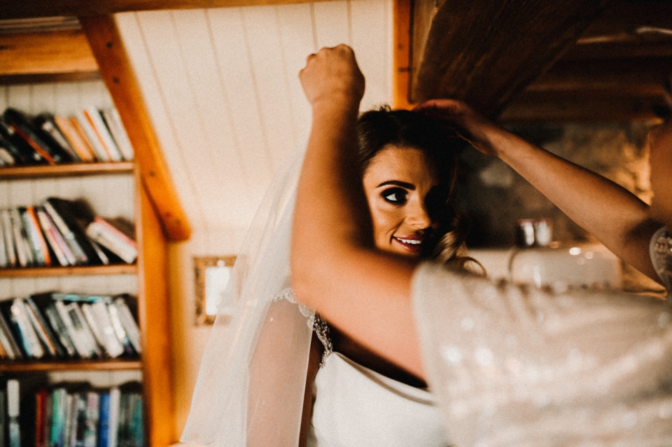 bride and best friend having final touch up prior to the ceremony