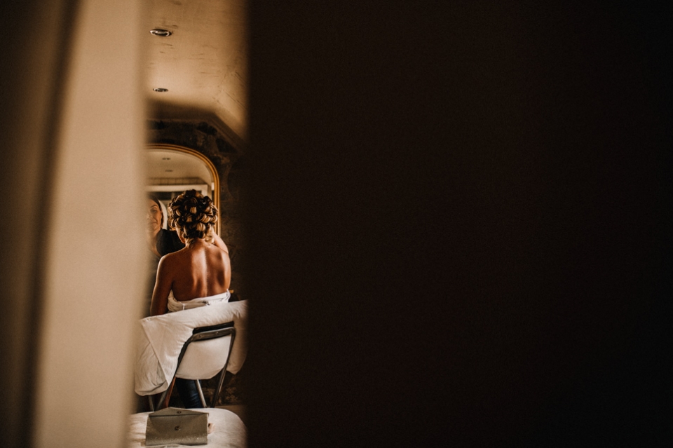 bride having her makeup done and hair in rollers