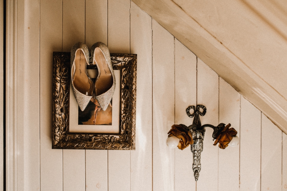 brides shoes hanging on artwork at Clenaghans hotel