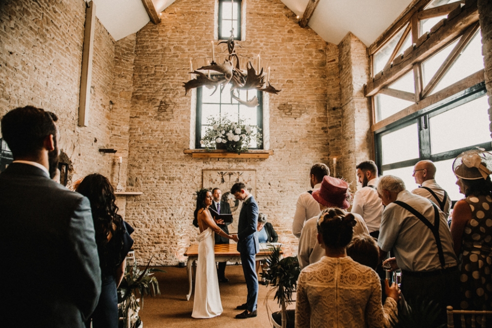 bridge and groom at the stone barn wedding ceremony in Merris Court