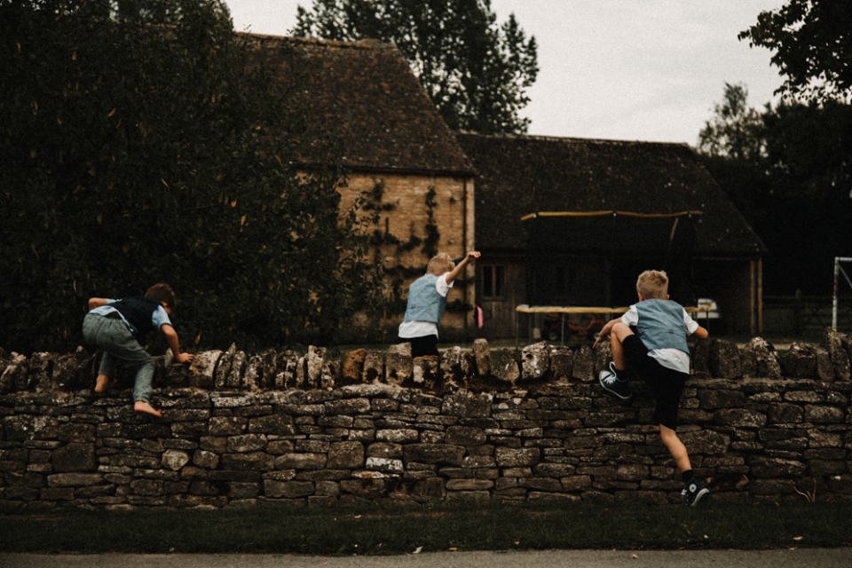 page boys having fun at the family farm wedding , Chipping Norton