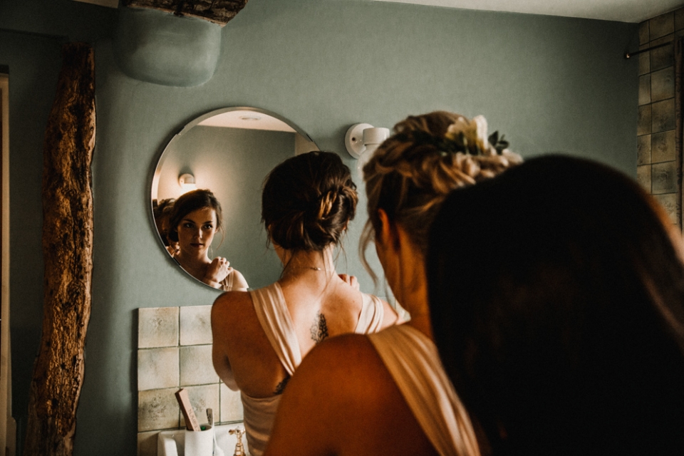 Bridesmaids getting into their dresses at Merriscourt wedding venue