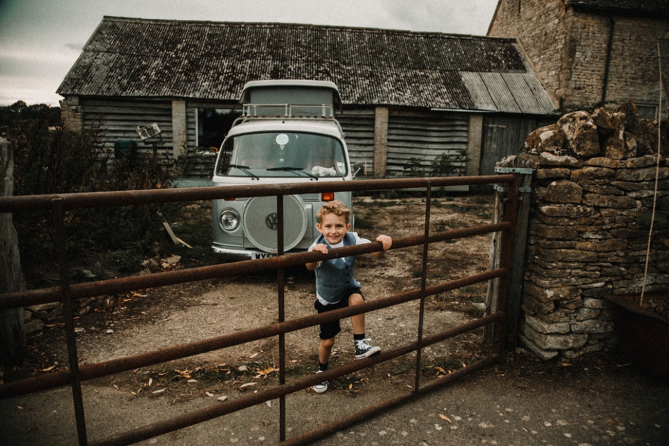 page boys having fun on the wedding farm