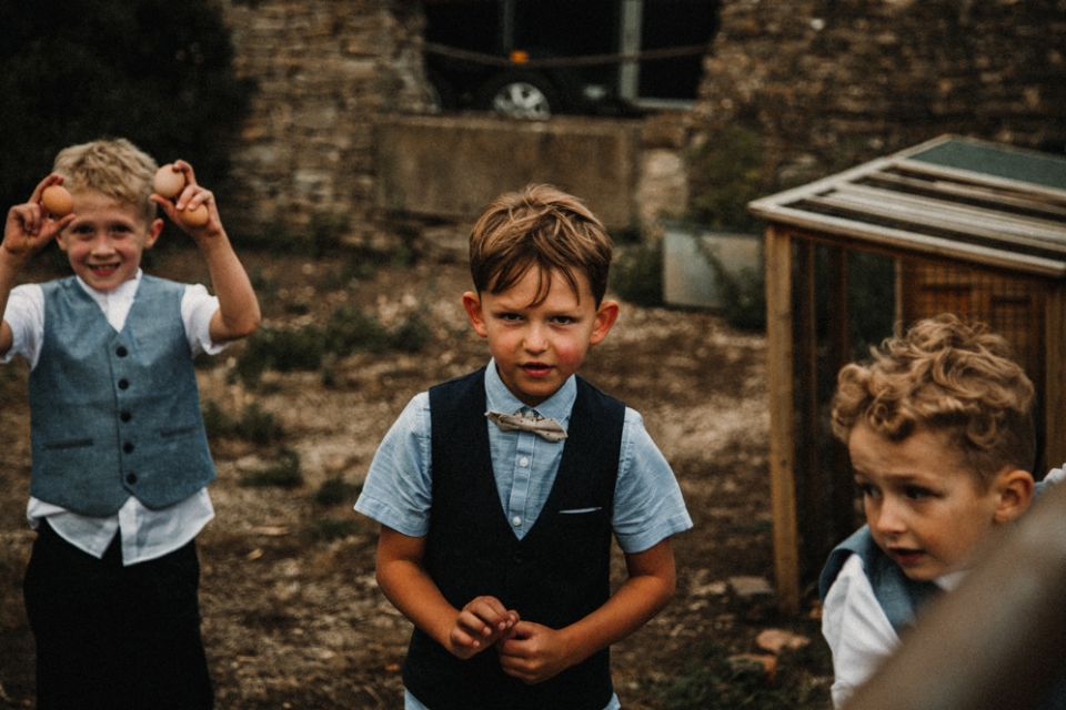 page boys picking eggs at the wedding reception