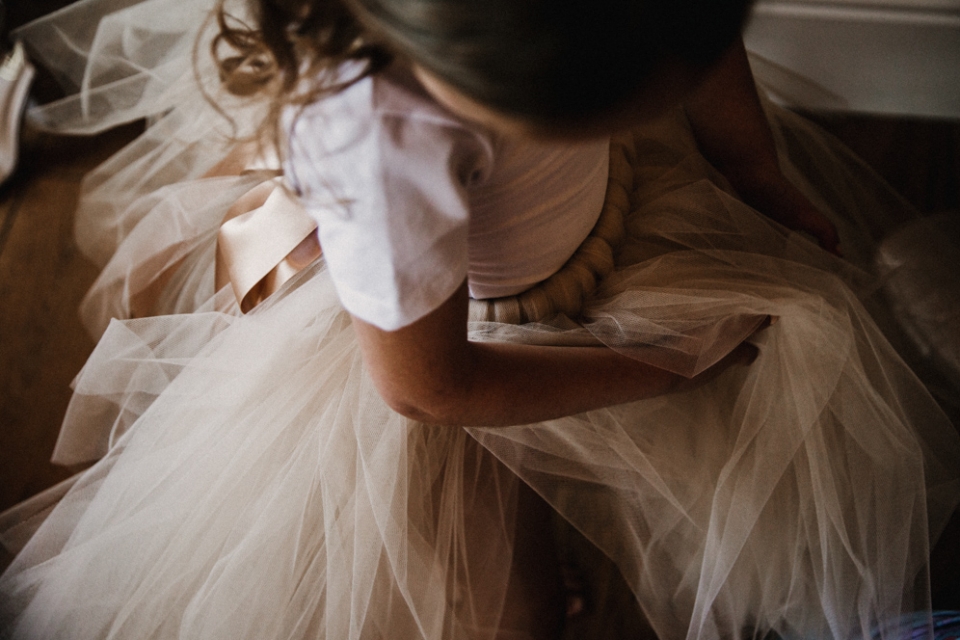 flower girl putting her dress on in the west mill bridal suite