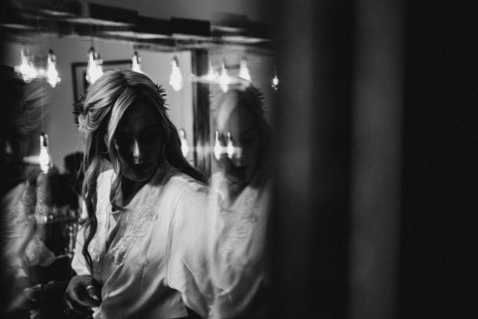 bride having her makeup done and hair in rollers