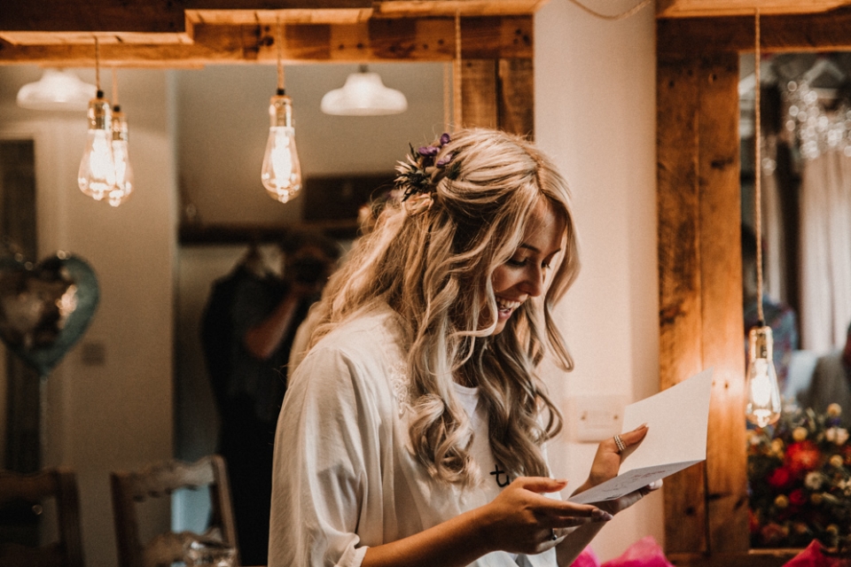 bride reading her card from her husband , derby wedding photography