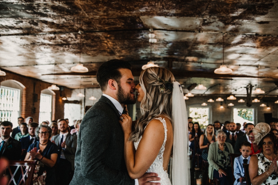 first kiss at industrial derby wedding ceremony