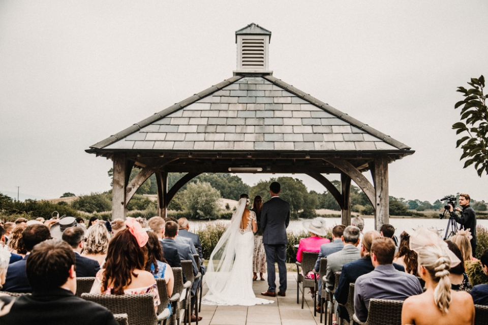out door ceremony on the lake at sandhole oak barns