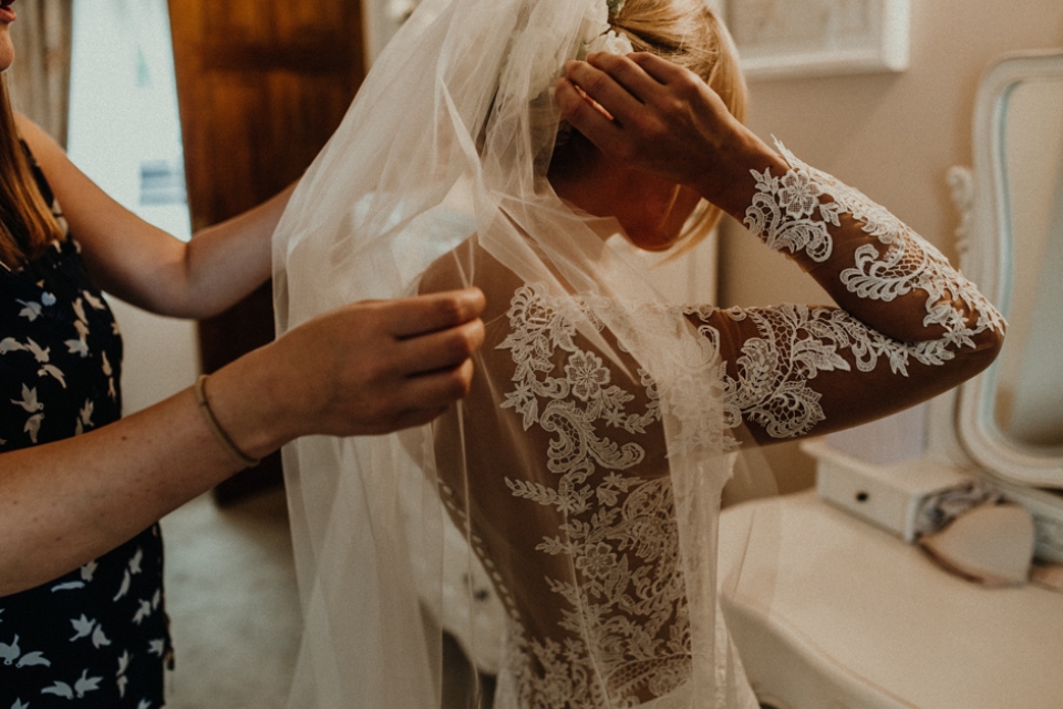 bride putting her veil in during bridal prep