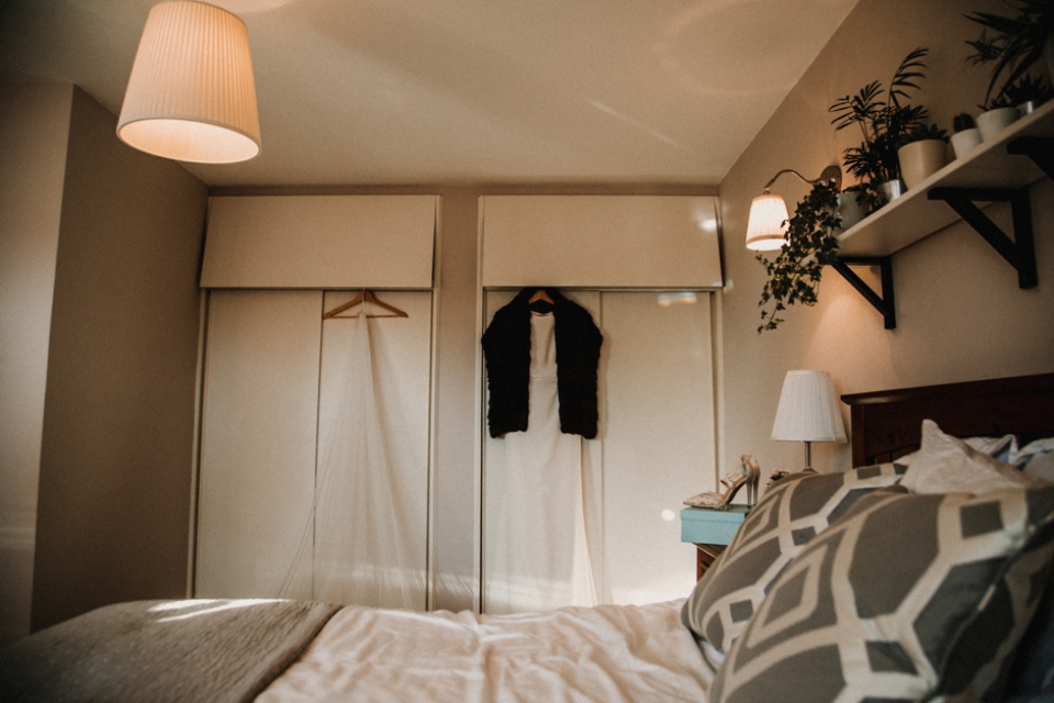 bridal gown hanging in modern bedroom , wedding photography in scotland