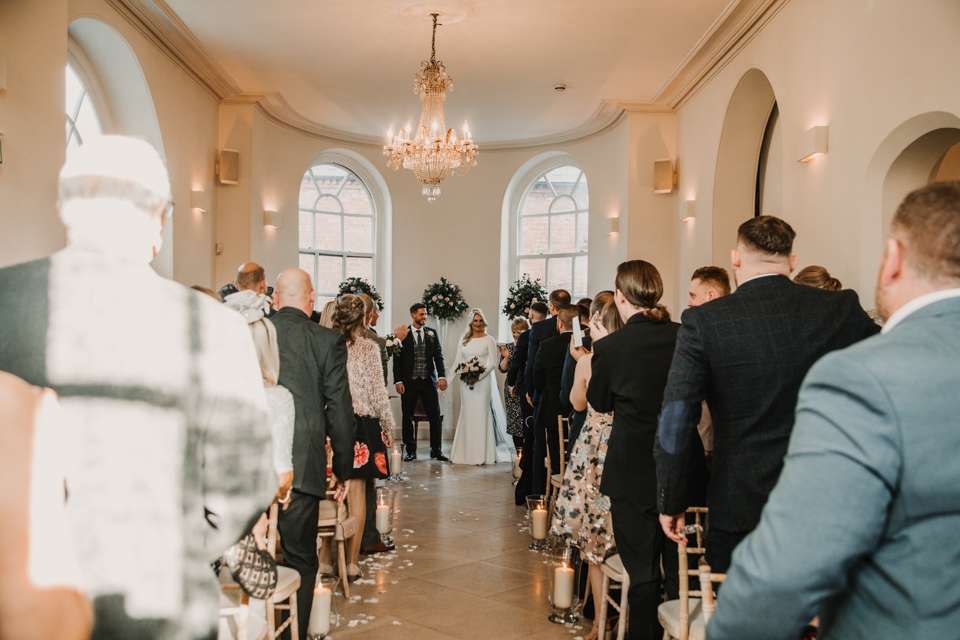 bride and groom walking down the sale together 