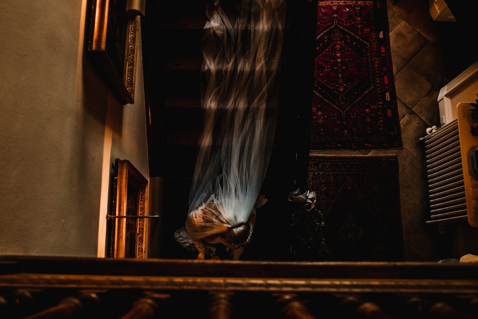 bride walking down the great stairs at the clock tower towards the ceremony