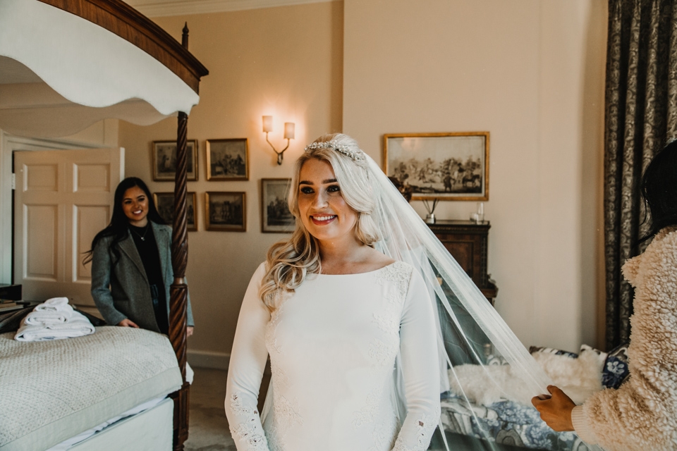 bride having her veil fitted during bridal prep