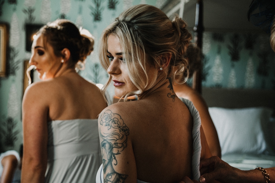 bridesmaids putting their gowns on