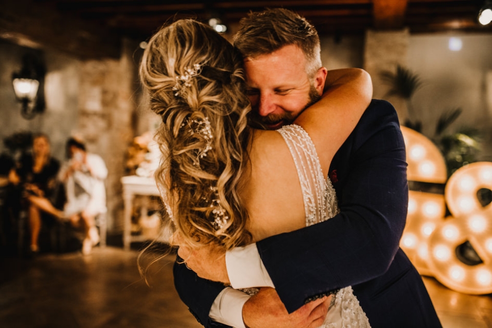 intimate moment between bride and groom as husband and wife , first dance