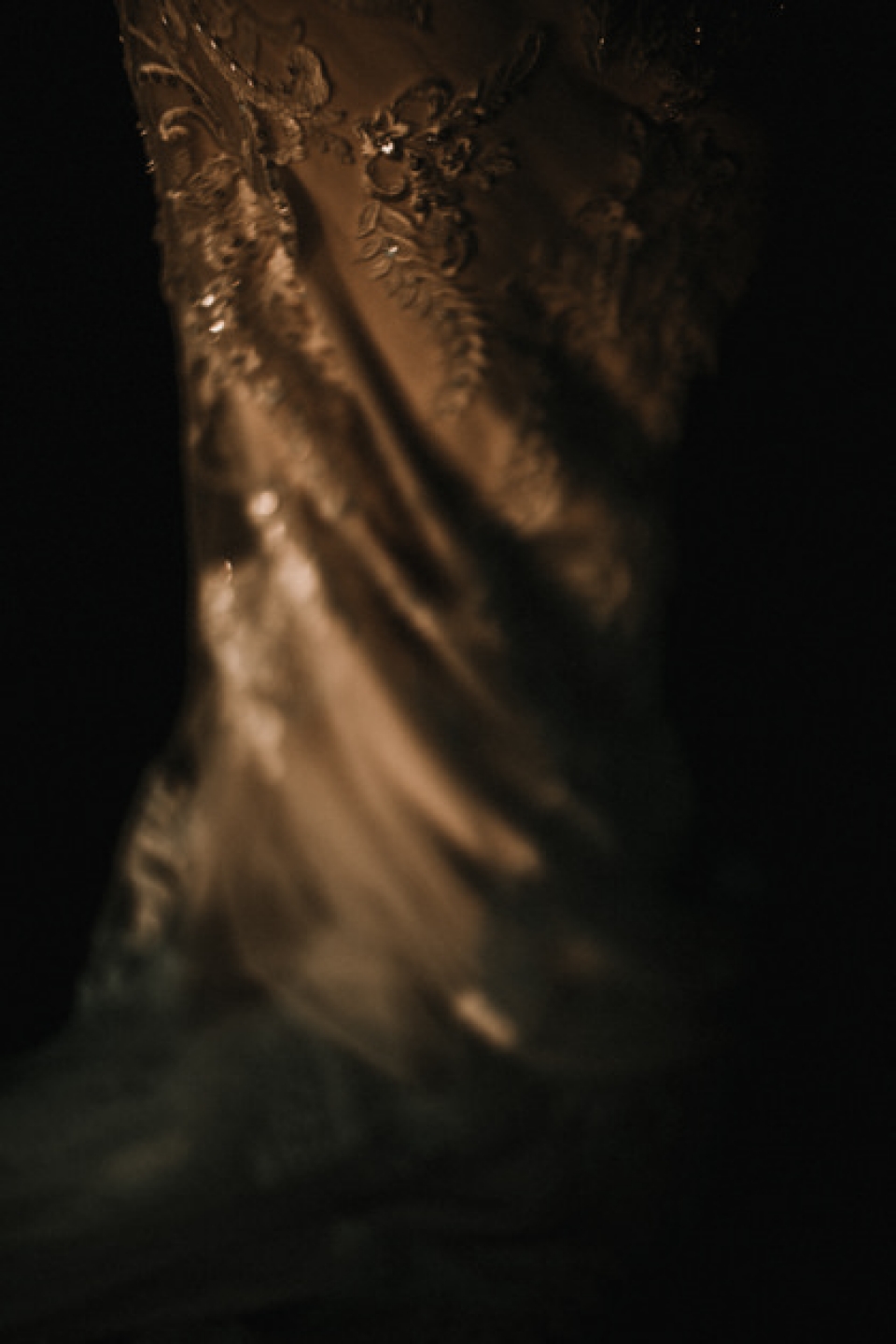 close up of brides dress in golden hour 