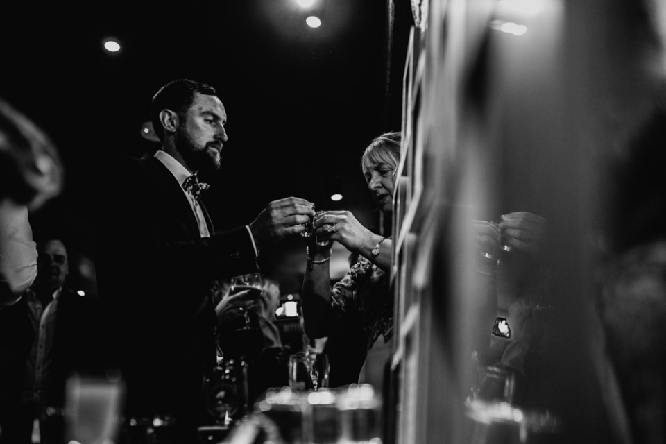 couple enjoying tequila at their wedding evening party