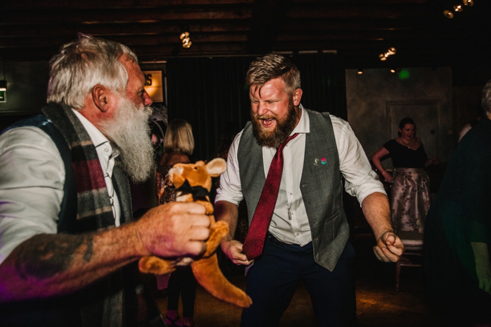 groom and father of the groom enjoying a dance off at le petit chateau