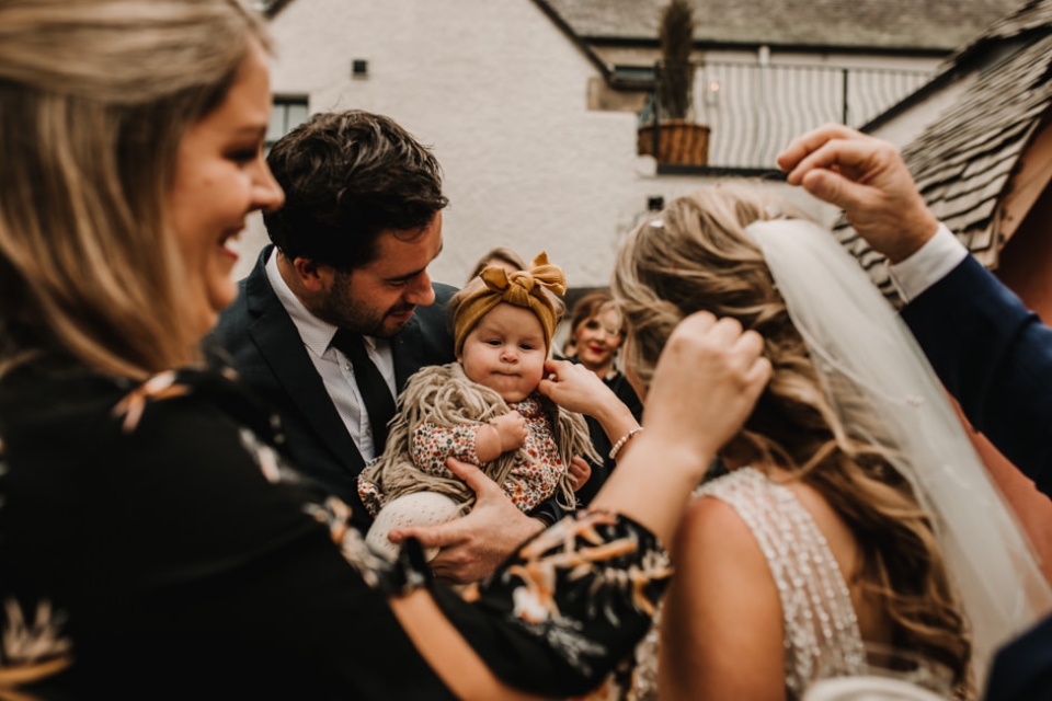 guests picking confetti from bride hair 