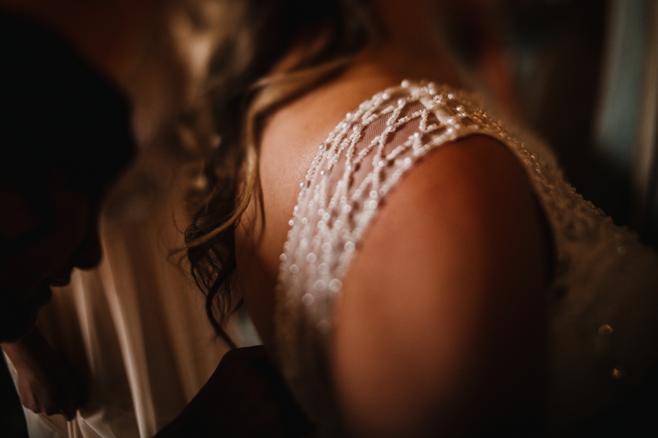 creative free lensed image of brides shoulder bead detail