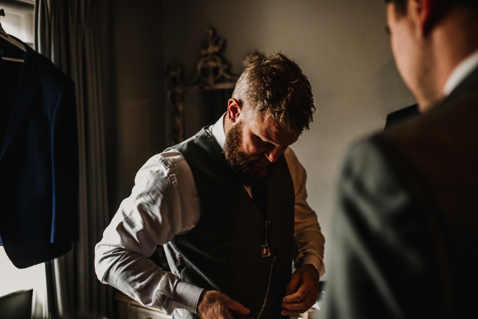 groom getting dressed during groom prep