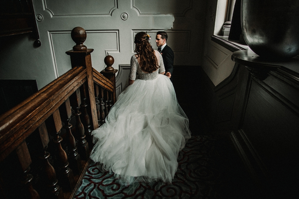 bride and groom inning down the stairs for some alone time