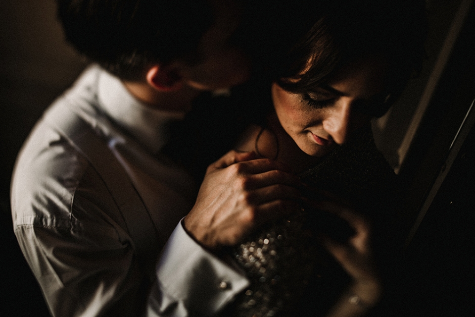 bride and groom holding hands in a very intimate cuddle