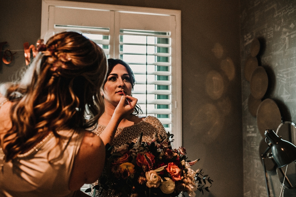 bride having final makeup touch up 