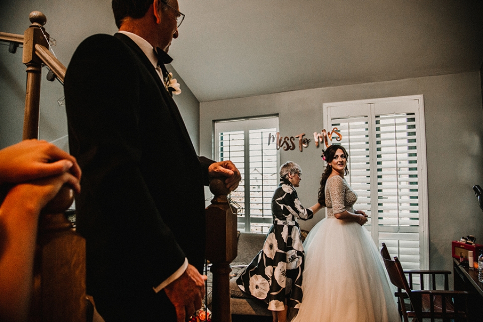 father of bride walking down the stairs and locking eyes with his daughter 