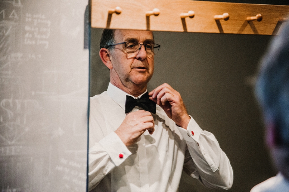 father of bride doing his bow tie