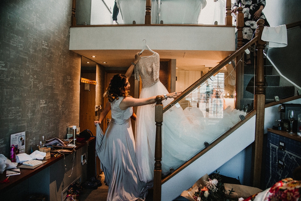 bridesmaid bringing down the dress