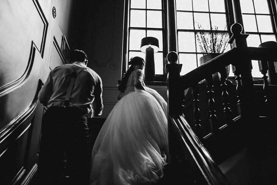 bide and groom walking up the stairs